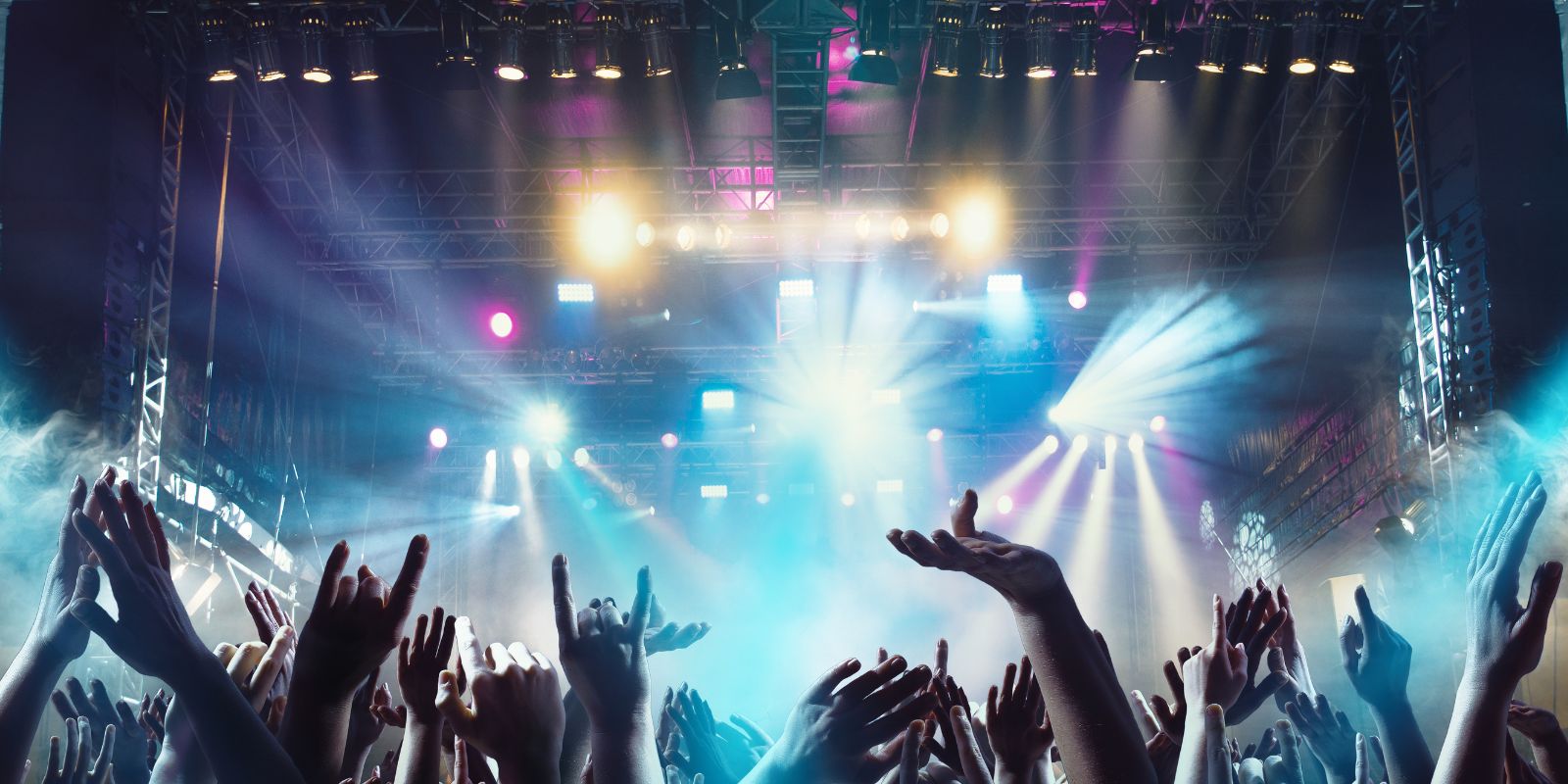 Crowd of people at a live concert with blue lights