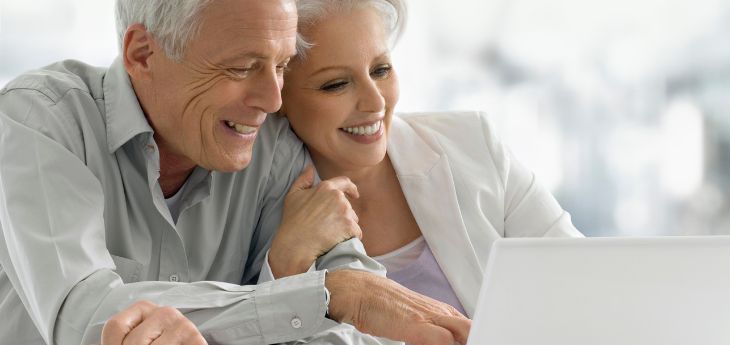 a man and woman looking at a laptop