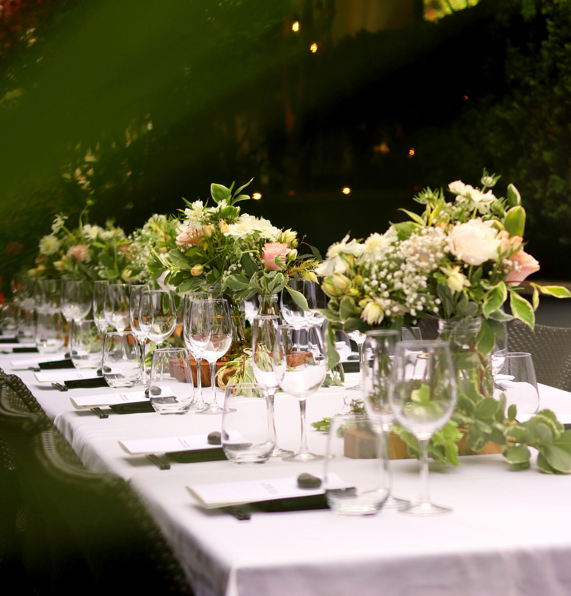 wedding table with flower arrangements and wine glasses